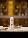 Candle illuminated on table beside plates on a baptism ceremony in a church in Bavaria Germany Royalty Free Stock Photo