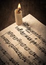 Candle illuminates the music paper