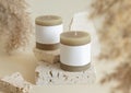 Candle with label on beige stone near dried pampas grass close up, copy space, mock up