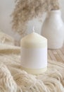 Candle with label on cosy sweater near dry pampas grass, Close up, mock up