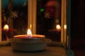 Candle in a lamp close-up with copy space on a dark background with bokeh. Focus with shallow depth of field