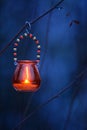 Candle lantern hanging from tree branch Royalty Free Stock Photo