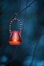 Candle lantern hanging from tree branch Royalty Free Stock Photo