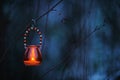 Candle lantern hanging from tree branch Royalty Free Stock Photo