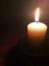 Candle light in the dark. Various brightness from fire. No wind. Copy space. Royalty Free Stock Photo