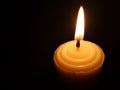 Candle light in the dark. Various brightness from fire. No wind. Copy space. Royalty Free Stock Photo