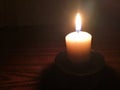 Candle light in the dark. Various brightness from fire. No wind. Copy space. Royalty Free Stock Photo