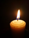 Candle light in the dark. Various brightness from fire. No wind. Copy space. Royalty Free Stock Photo