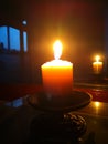 Candle light in the dark. Various brightness from fire. No wind. Copy space. Royalty Free Stock Photo