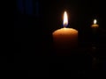 Candle light in the dark. Various brightness from fire. No wind. Copy space. Royalty Free Stock Photo