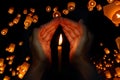 Candle light in hand with Floating lantern in the night sky background Royalty Free Stock Photo