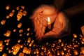 Candle light in hand with Floating lantern in the night sky background Royalty Free Stock Photo