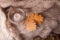 Candle light,pink scarf on a wooden background. Winter cosiness mood, top view, Cozy Winter Autumn Evening