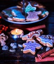 Candle light table with Christmas gingerbread cookies .
