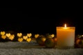 Candle lights and Christmas ornaments with golden love shape bokeh lights. Royalty Free Stock Photo