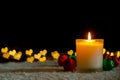 Candle lights and Christmas ornaments with golden love shape bokeh lights. Royalty Free Stock Photo