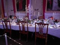 Candle-lit dinner table inside a historic hall