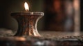 a candle is lit on a table in a dark room with a blurry background of the candle and the table cloth on the floor Royalty Free Stock Photo
