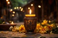 a candle is lit on a table surrounded by yellow flowers Royalty Free Stock Photo