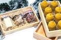 Candle made of natural wax and different nuts in a wooden box, a gift