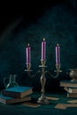 Candle magic. Purple candles and occult books