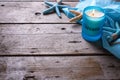 Candle and marine items on wooden background.