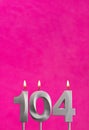 Candle number 104 - Birthday celebration on fuchsia background