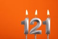 Candle number 121 - Birthday in orange background