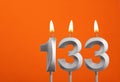 Candle number 133 - Birthday in orange background