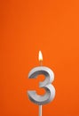 Candle number 3 - Birthday in orange foamy background