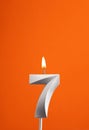 Candle number 7 - Birthday in orange foamy background