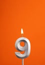 Candle number 9 - Birthday in orange foamy background