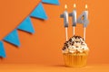 Candle number 114 - Cake birthday in orange background Royalty Free Stock Photo