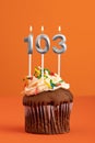 Candle number 103 - Cake birthday in orange background