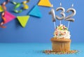 Candle number 132 - Cupcake birthday in blue background Royalty Free Stock Photo
