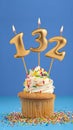 Candle number 132 - Cupcake birthday in blue background Royalty Free Stock Photo