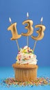 Birthday cupcake with candle number 133 - Blue background
