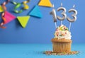 Birthday cupcake with candle number 133 - Blue background