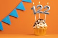 Candle number 122 - Cupcake birthday in orange background