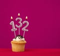 Birthday cupcake with candle number 132 - Rhodamine Red foamy background