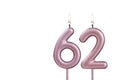 Candle number 62 - Lit birthday candle on white background
