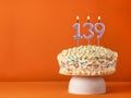 Candle number 139 - Vanilla cake in orange background Royalty Free Stock Photo