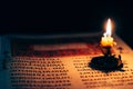 Candle on open Bible Royalty Free Stock Photo