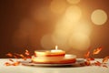 a candle on a plate with leaves and orange ribbons Royalty Free Stock Photo