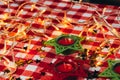 Candle on red checkered tablecloths and garland Royalty Free Stock Photo