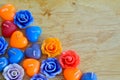 Candle roses and candle hearts on wooden background