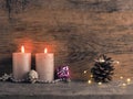 Candle of the second Advent burns, pine cones and Christmas decoration on wood Royalty Free Stock Photo