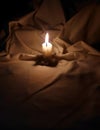 A candle shining in dark background.