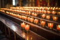 candle stand with votive candles inside an empty church