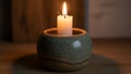 The candle stands upright its flame gently flickering casting a soft glow Royalty Free Stock Photo